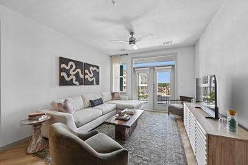 San Antonio apartment for rent - A living room with a white couch and a grey rug.