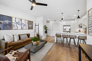 Las Vegas apartment for rent - A modern living room with a brown sofa and a grey coffee table.