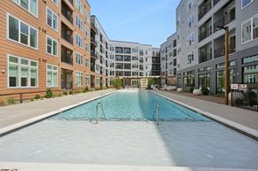 Charlotte apartment for rent - A swimming pool in front of apartment buildings.