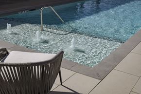 Sherman apartment for rent - A chair is placed by a pool with water jets.