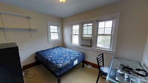 Ann Arbor apartment for rent - A bedroom with a bed, chair, and window.