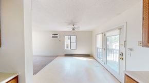 Ann Arbor triplex for rent - A spacious, empty room with a door and a window.