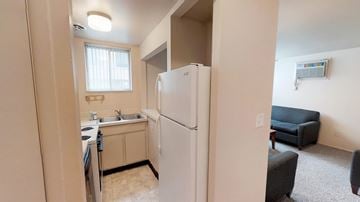 Ann Arbor apartment for rent - A kitchen area with a refrigerator, sink, and microwave.