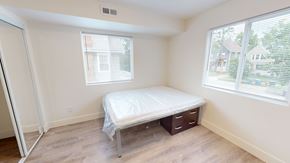 Ann Arbor apartment for rent - A bedroom with a bed, nightstand, and window.