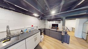 Ann Arbor apartment for rent - A kitchen with a sink and a grey couch.