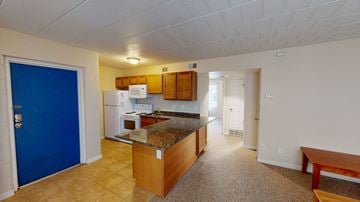 Ann Arbor apartment for rent - A kitchen with a blue door and white appliances.