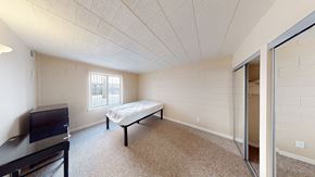 Ann Arbor apartment for rent - A bedroom with a bed, dresser, and television.