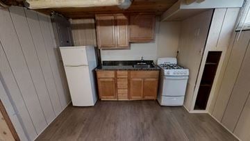 Ann Arbor apartment for rent - A kitchen with wooden cabinets and a white fridge.