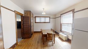 Ann Arbor apartment for rent - A room with a wooden floor and a table with chairs.