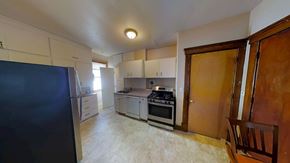 Ann Arbor house for rent - A kitchen with a refrigerator, oven, and stove.