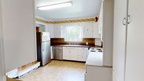 Ann Arbor apartment for rent - A kitchen with white appliances and cabinets.