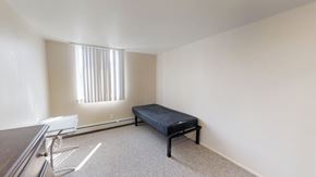 Ann Arbor apartment for rent - A room with a bed, chair, and window.