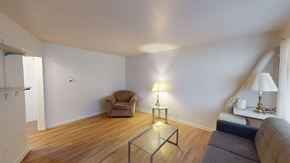 Ann Arbor apartment for rent - A living room with a grey couch, a chair, and a coffee table.
