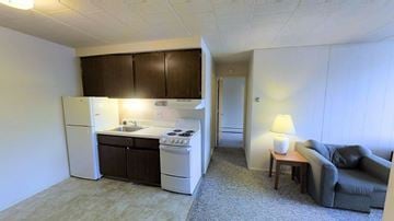 Ann Arbor apartment for rent - A small kitchen with a refrigerator, oven, and sink.