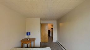 Ann Arbor apartment for rent - A room with a table and a bed.