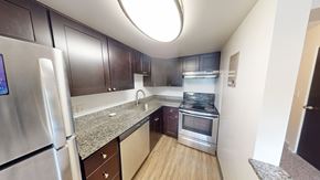 Ann Arbor apartment for rent - A kitchen with a refrigerator, oven, and microwave.