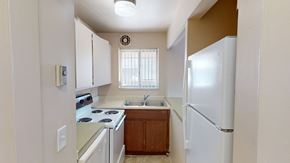 Ann Arbor apartment for rent - A kitchen with white appliances and wooden cabinets.