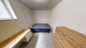 Ann Arbor apartment for rent - A bedroom with a bed, dresser, and window.