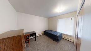 Ann Arbor apartment for rent - A room with a bed, desk, and chair.