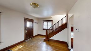 Ann Arbor apartment for rent - A room with a wooden floor and a staircase.