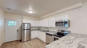 Ann Arbor apartment for rent - A kitchen with white cabinets and a granite countertop.
