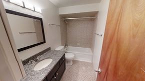 Ann Arbor apartment for rent - A bathroom with a sink, toilet, and shower.