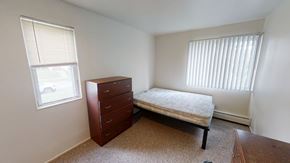 Ann Arbor apartment for rent - A bedroom with a bed, dresser, and window.