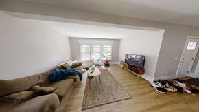 Ann Arbor apartment for rent - A living room with a couch, rug, and television.