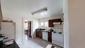 Ann Arbor apartment for rent - A kitchen with white appliances and a black counter.
