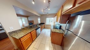 Ann Arbor apartment for rent - A kitchen with wooden cabinets and granite countertops.