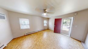 Ann Arbor apartment for rent - A room with a ceiling fan and wooden flooring.