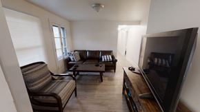 Ann Arbor apartment for rent - A living room with a couch, chair, and television.