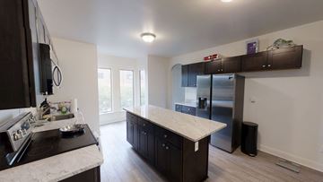 Ann Arbor apartment for rent - A kitchen with a stove top oven and a refrigerator.