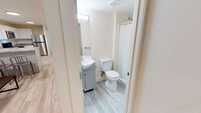 Ann Arbor apartment for rent - A bathroom with a toilet and sink is visible through a doorway.