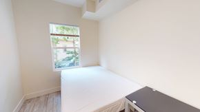 Ann Arbor apartment for rent - A bedroom with a bed, desk, and window.
