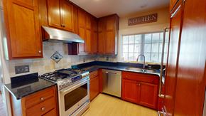 Ann Arbor apartment for rent - A kitchen with wooden cabinets and a stove top oven.