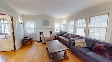 Ann Arbor apartment for rent - A living room with a grey couch and a wooden coffee table.