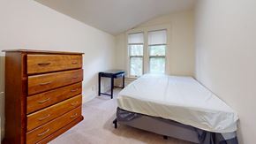 Ann Arbor apartment for rent - A bedroom with a bed, dresser, and desk.