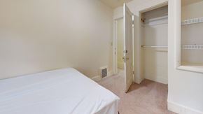 Ann Arbor apartment for rent - A bedroom with a bed, closet, and a door leading to another room.
