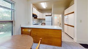 Ann Arbor apartment for rent - A kitchen with a table and chairs in front of a window.