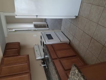 Ann Arbor apartment for rent - A kitchen with brown countertops and a white oven.