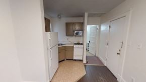 Ann Arbor apartment for rent - A kitchen with white appliances and a white refrigerator.