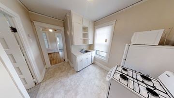 Ann Arbor apartment for rent - A kitchen with a stove top oven and a refrigerator.