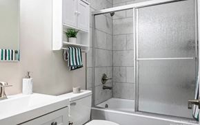 Ann Arbor apartment for rent - A white bathroom with a glass shower door.