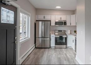 Ann Arbor apartment for rent - A kitchen with a refrigerator, oven, and microwave.