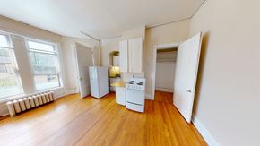 Ann Arbor apartment for rent - A kitchen with white appliances and wooden floors.
