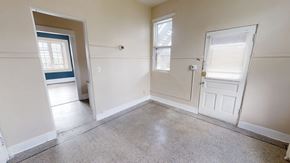 Ann Arbor apartment for rent - A room with a door, window, and a small opening to another room.