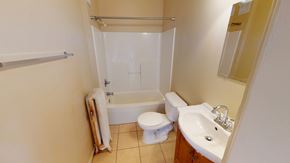 Ann Arbor apartment for rent - A small bathroom with a toilet, sink, and bathtub.