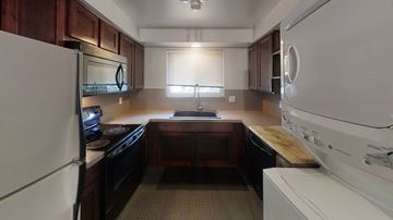 Ann Arbor apartment for rent - A kitchen with a white refrigerator and a white washing machine.