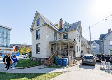 Ann Arbor apartment for rent - A house with a grey facade and a brown roof with a chimney.